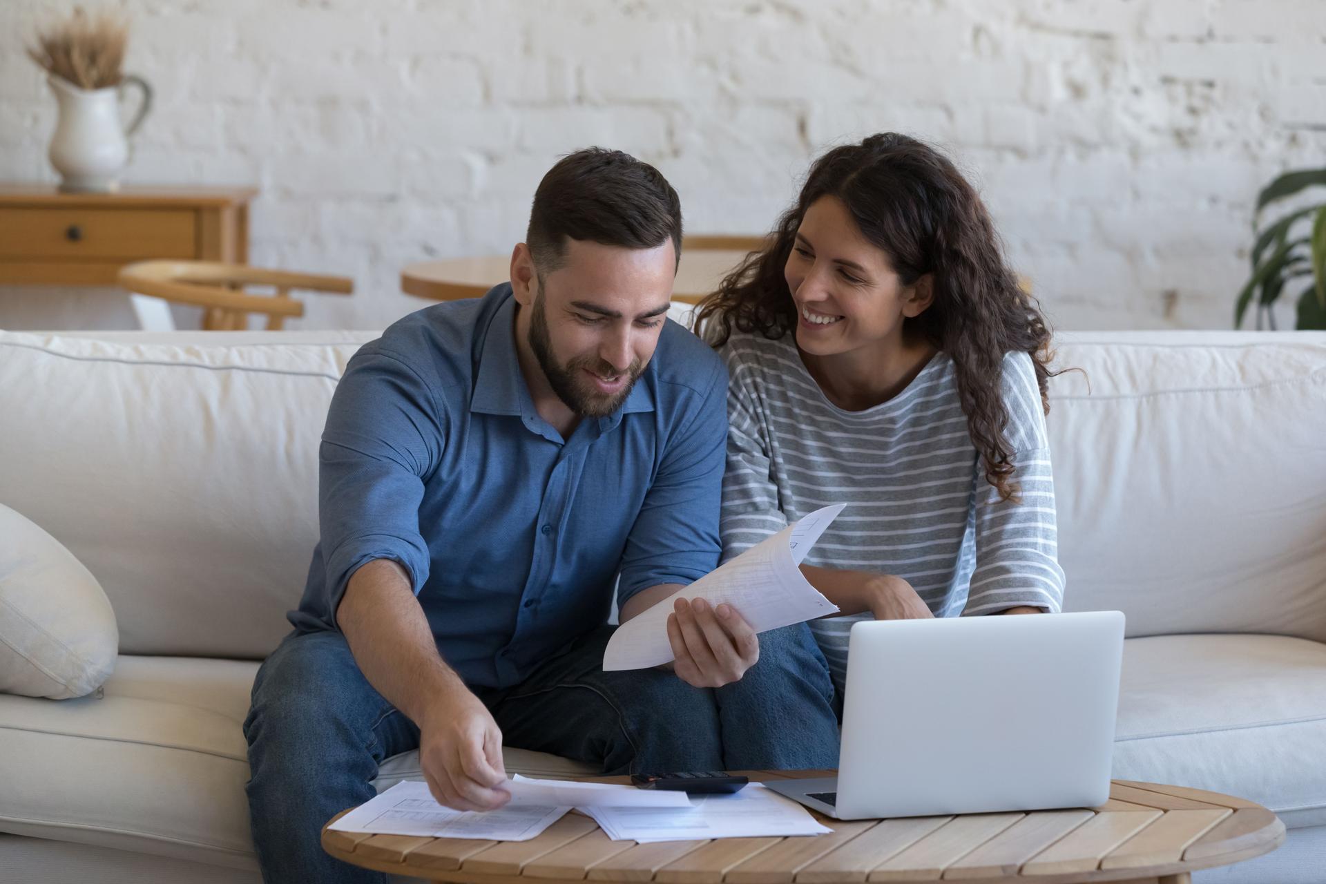 Happy couple of 30s renters, homeowners doing domestic accounting job