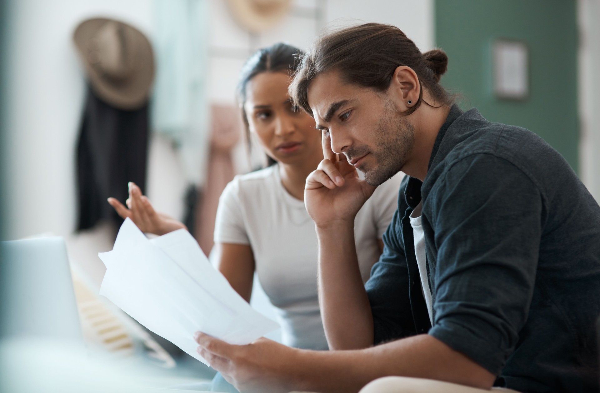 Shot of a young couple having an argument while doing paperwork at home